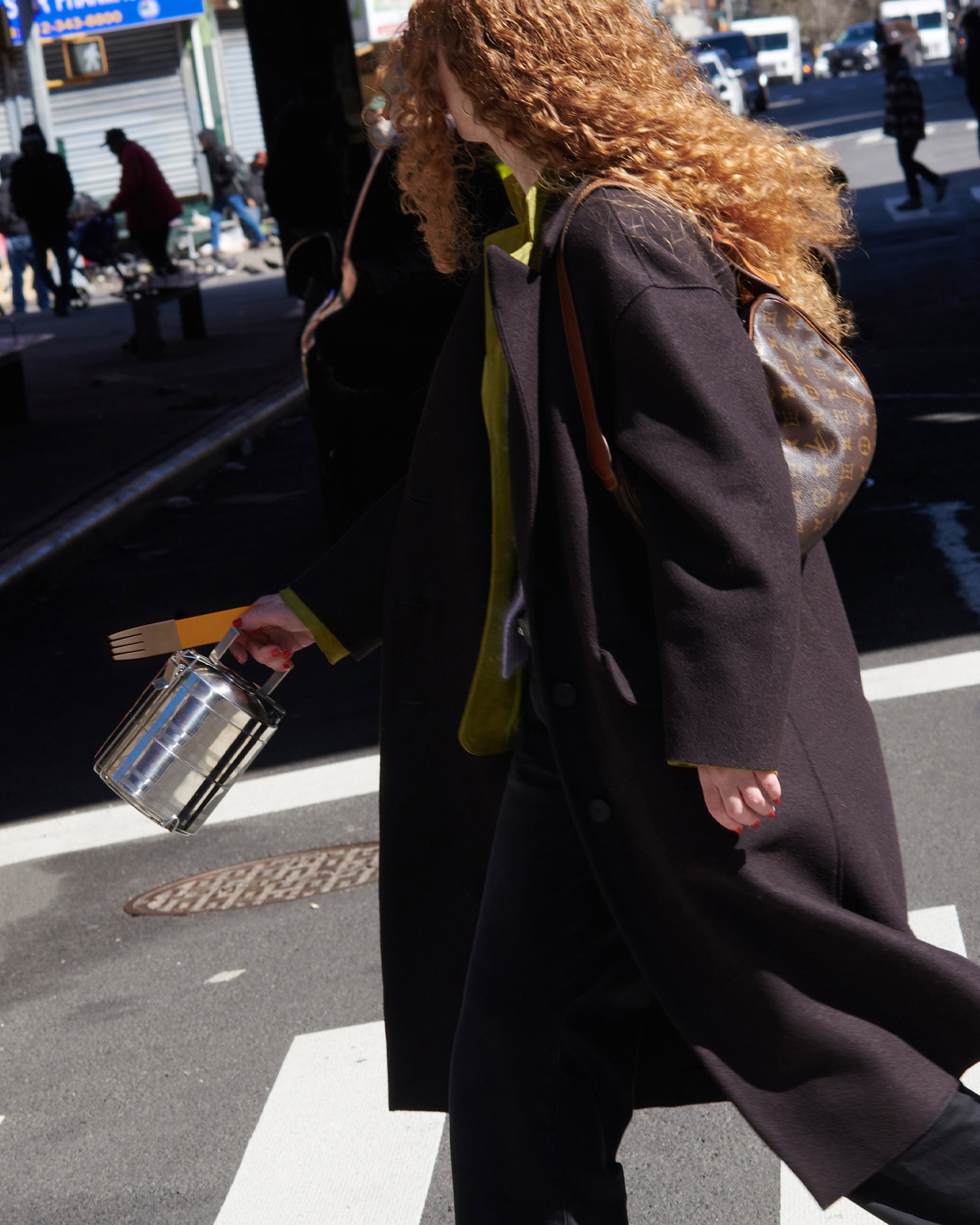 forks-plus-abby-street-stainless-tin-orange-fork Girl walking down the street carrying a stainless steel lunch tin and orange fork