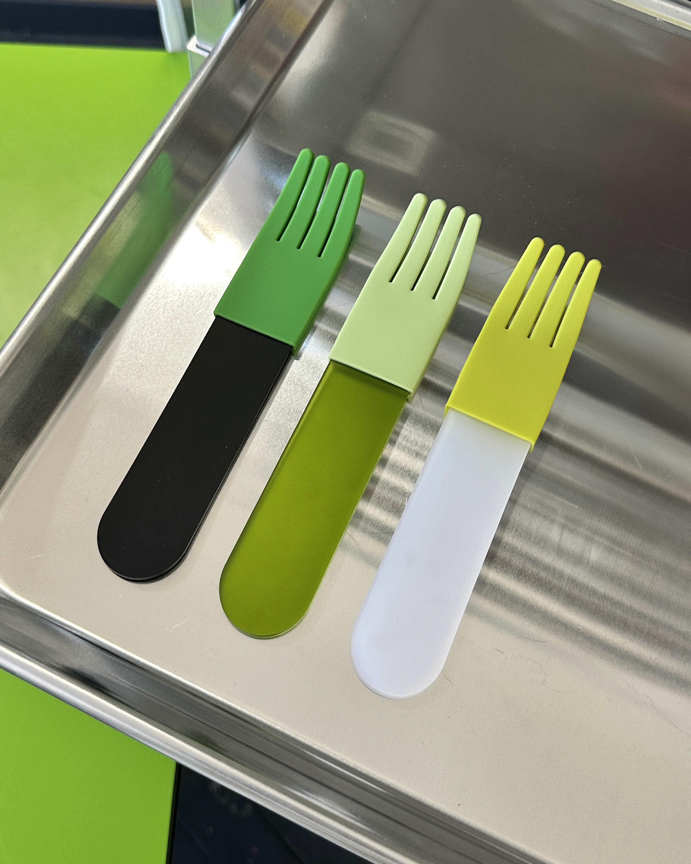forks-plus-green-acrylic-fork-trio-stainless-tray Trio of green acrylic forks sitting on stainless steel tray