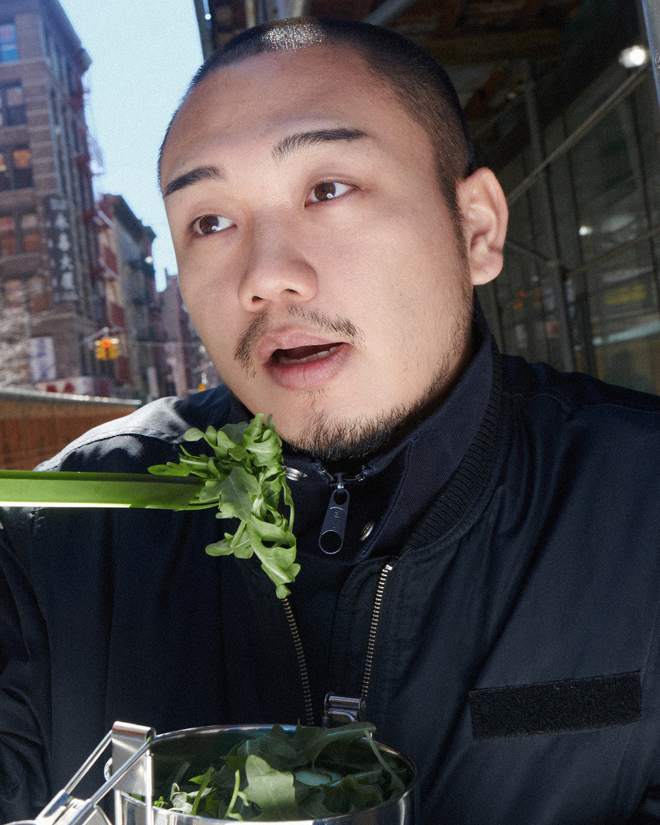 forks-plus-jinu-eating-salad-green-fork-city Man eating salad with green acrylic fork outdoors with city background